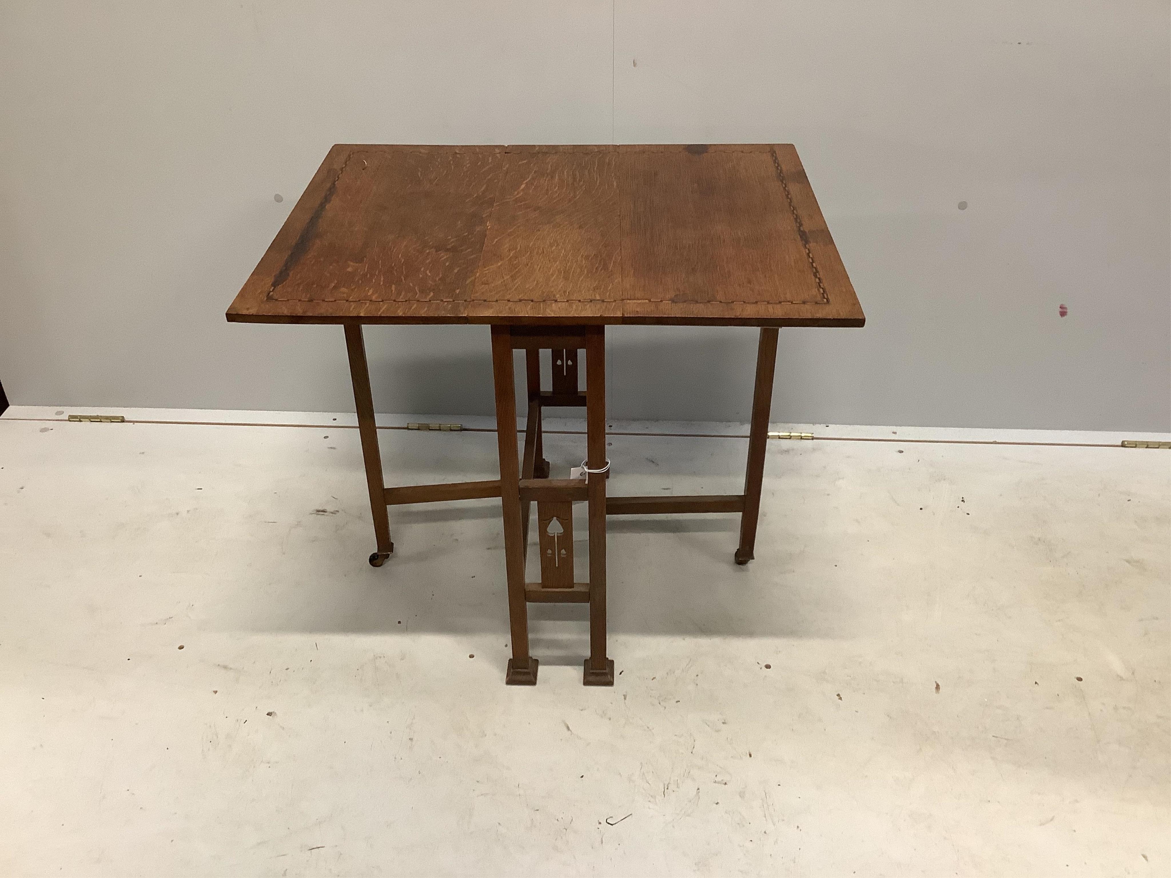 An Arts & Crafts inlaid oak Sutherland table, width 56cm, depth 20cm, height 60cm. Condition - fair